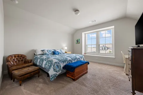 a spacious bedroom with a bed and a couch