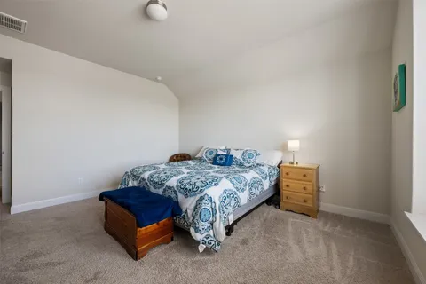 a bedroom with a bed and cabinets