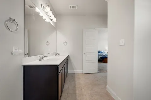 a bathroom with a sink a light fixture and a mirror