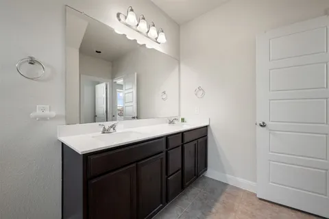 a bathroom with a double vanity sink and a mirror