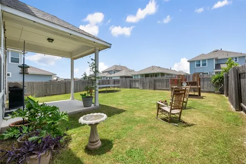 a view of a swimming pool with a table and chairs under an umbrella