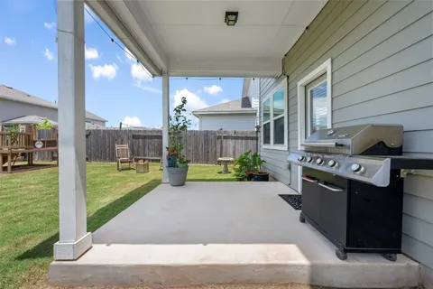 a view of a house with backyard and porch