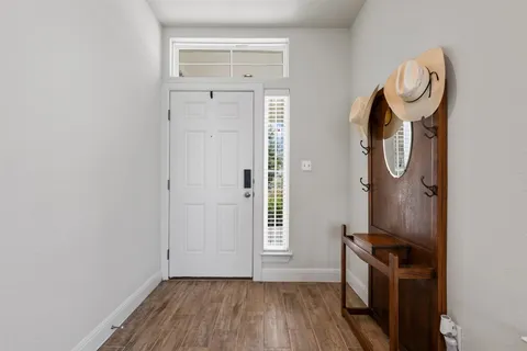 a view of a storage and utility room with wooden floor