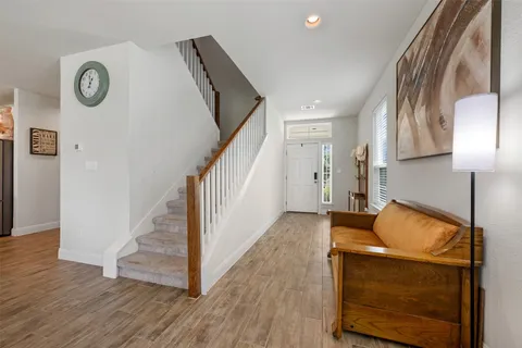 a room with wooden floor and entryway