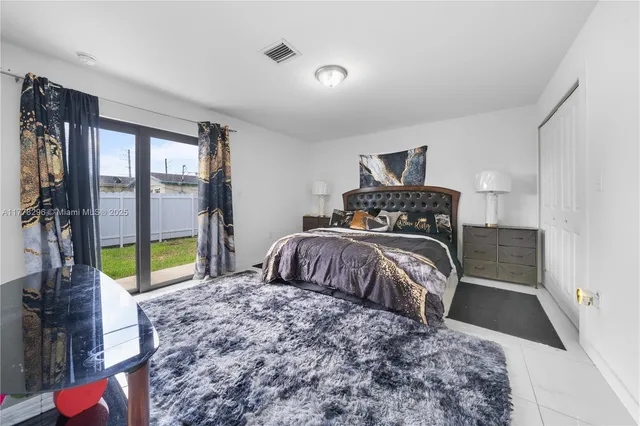 a bedroom with a bed next to a window