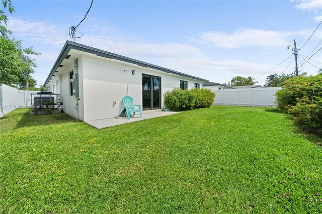 a view of a house with a yard and garage