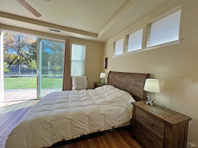 a bedroom with a bed and a tv on table
