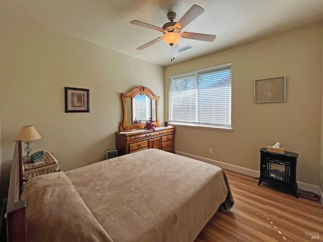 a bedroom with bed and a chandelier