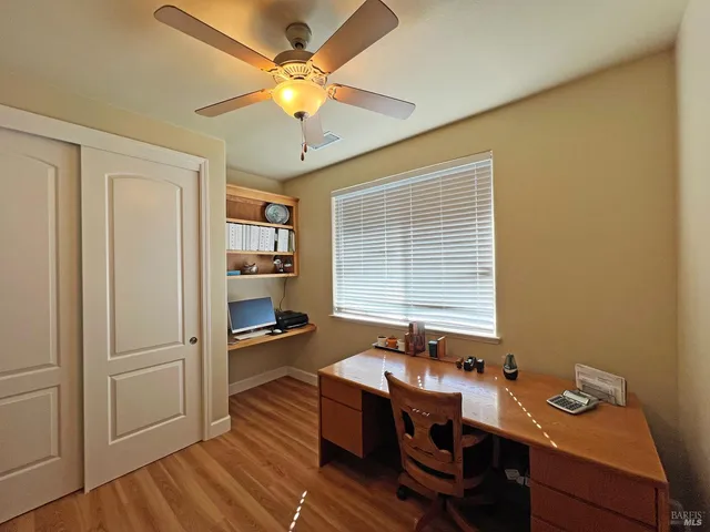 a spacious bathroom with a tub sink and mirror