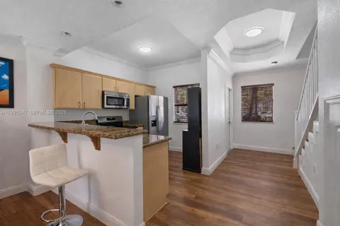 a kitchen with stainless steel appliances a refrigerator stove microwave and sink