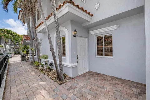 front view of a house with a garden and trees