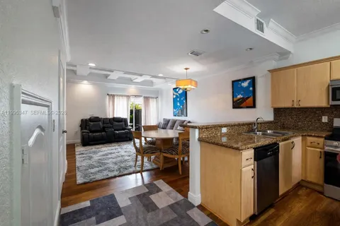 a kitchen with a stove a refrigerator and wooden cabinets