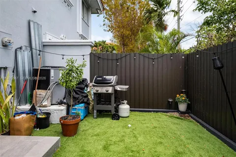 a view of a backyard with furniture and a fire pit
