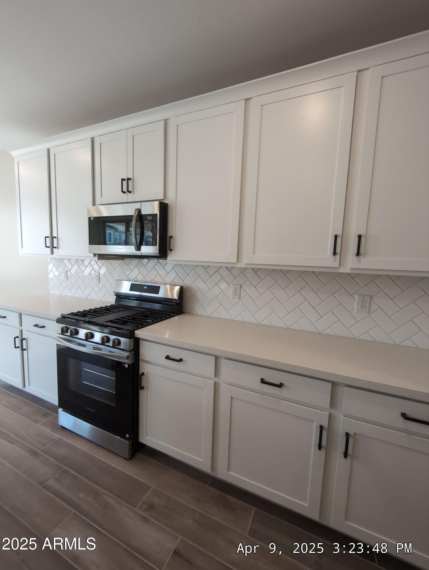 4514 South Pasteur Mesa, AZ 85212 - Photo 15 of 43 a kitchen with stainless steel appliances granite countertop a stove a sink and a microwave