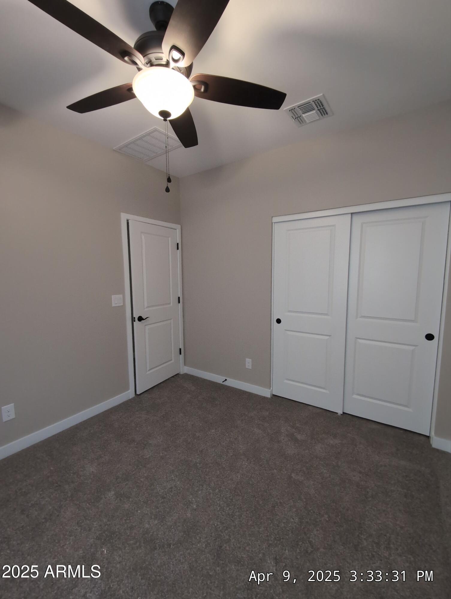 4514 South Pasteur Mesa, AZ 85212 - Photo 41 of 43 an empty room with a ceiling fan and a window