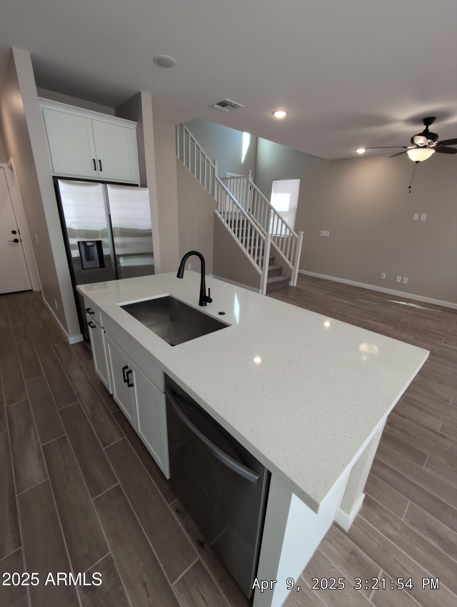 4514 South Pasteur Mesa, AZ 85212 - Photo 9 of 43 a kitchen with stainless steel appliances granite countertop a sink a stove and a wooden floors