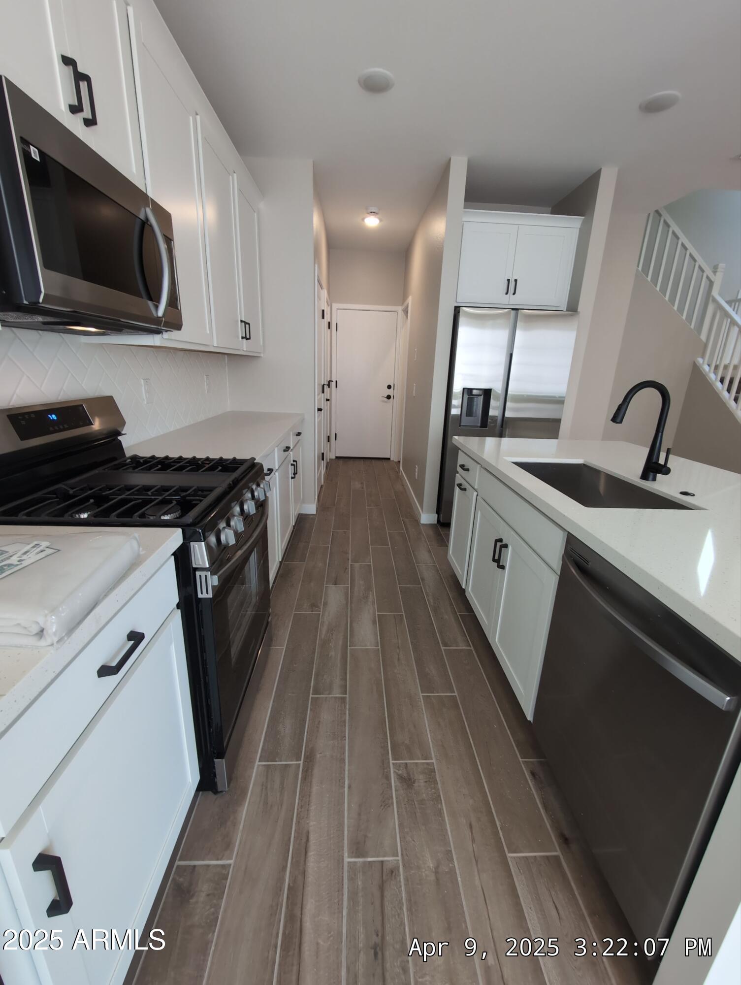 4514 South Pasteur Mesa, AZ 85212 - Photo 10 of 43 a kitchen with granite countertop a sink a stove and microwave