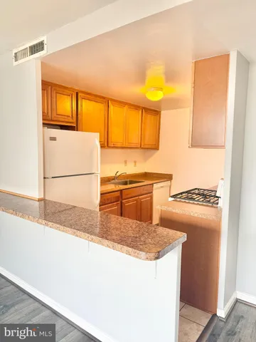 a kitchen with a stove a sink and a refrigerator