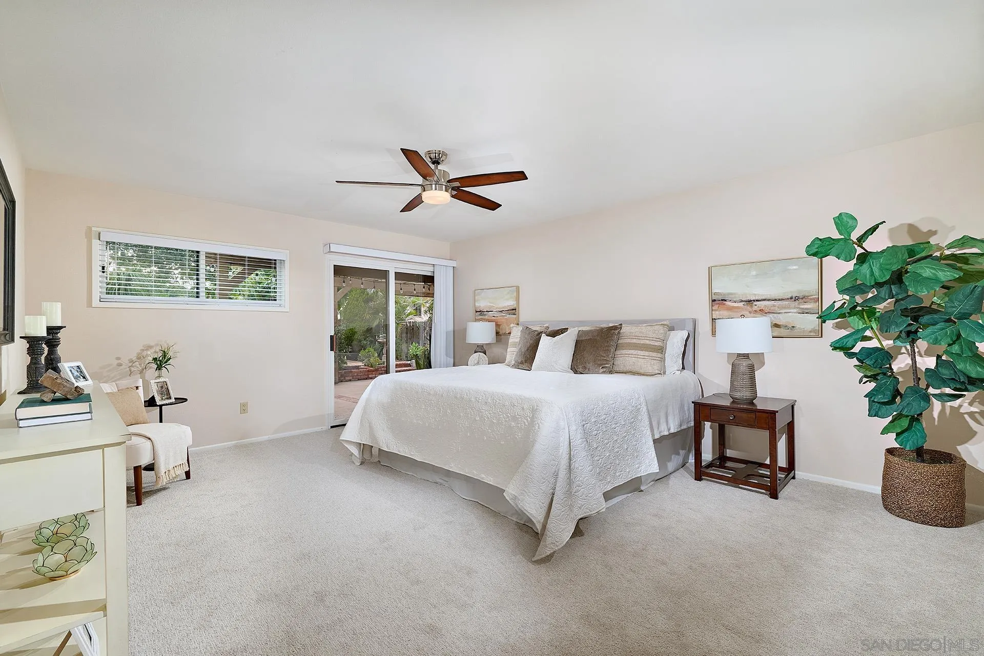 7627 Reposado Drive Carlsbad, CA 92009 - Photo 11 of 54 a bedroom with a large bed and a chandelier