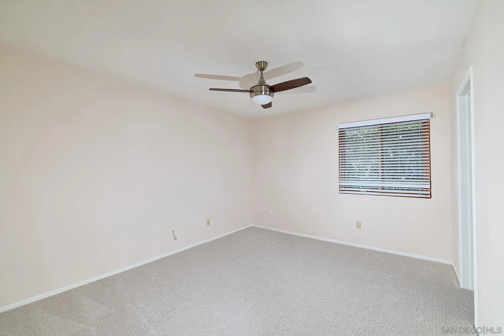 7627 Reposado Drive Carlsbad, CA 92009 - Photo 16 of 54 an empty room with a window and a ceiling fan