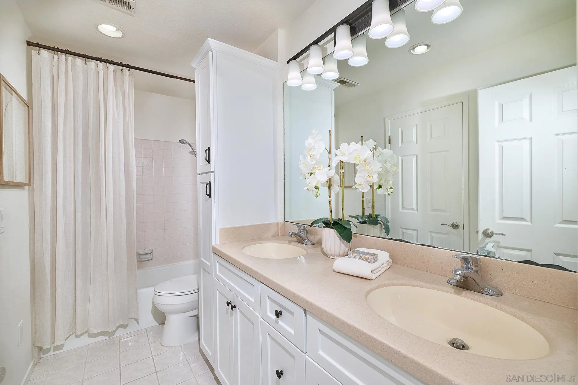 7627 Reposado Drive Carlsbad, CA 92009 - Photo 17 of 54 a bathroom with a granite countertop sink a toilet and a mirror