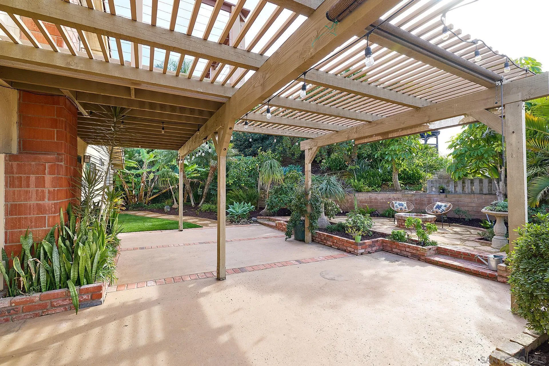 7627 Reposado Drive Carlsbad, CA 92009 - Photo 37 of 54 a view of a patio with table and chairs next to a yard