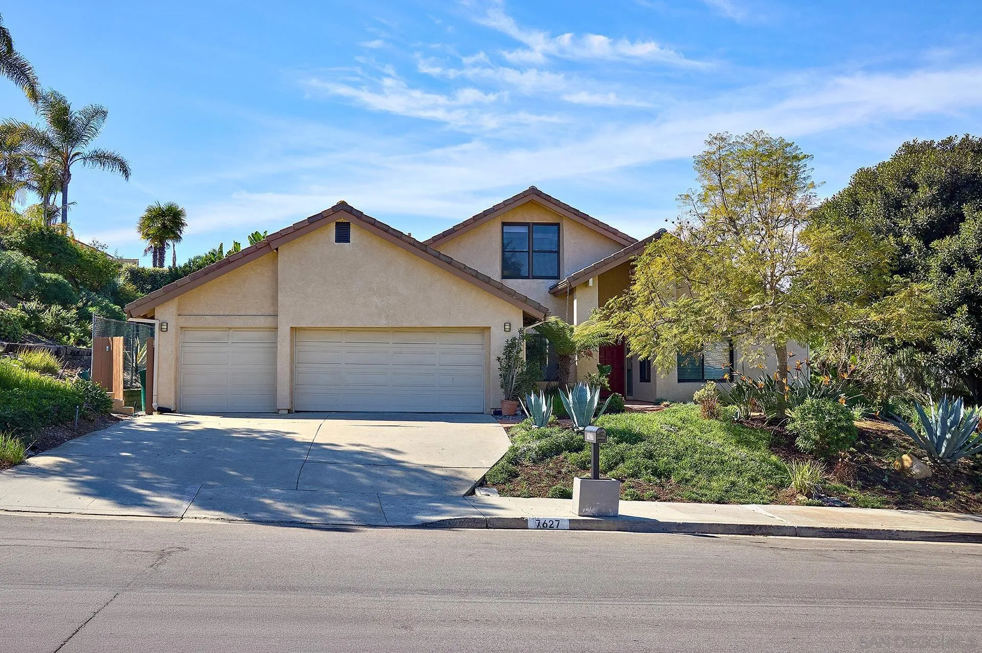 7627 Reposado Drive Carlsbad, CA 92009 - Photo 41 of 54 a front view of a house with a yard and garage