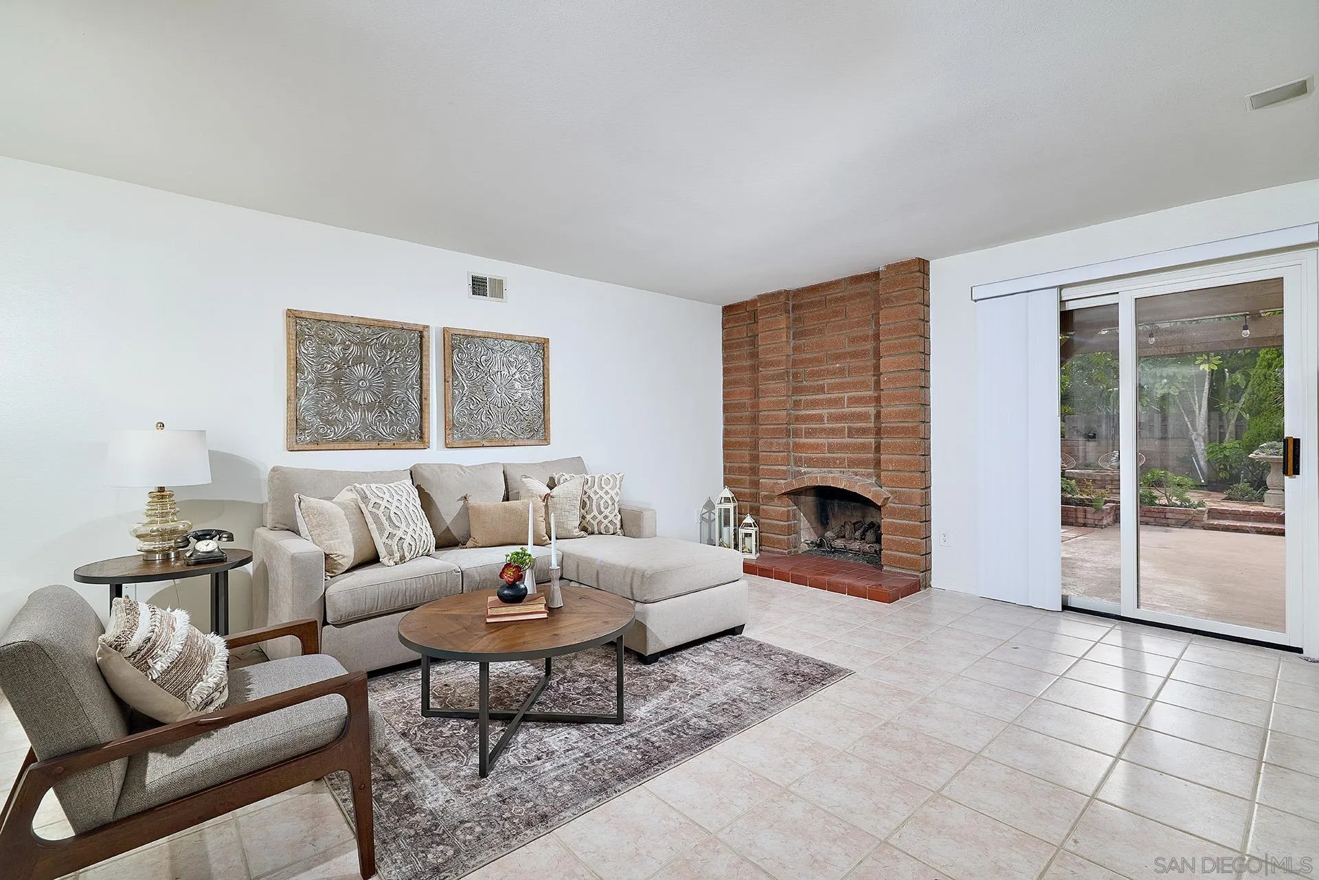 7627 Reposado Drive Carlsbad, CA 92009 - Photo 6 of 54 a living room with furniture a fireplace and a large window