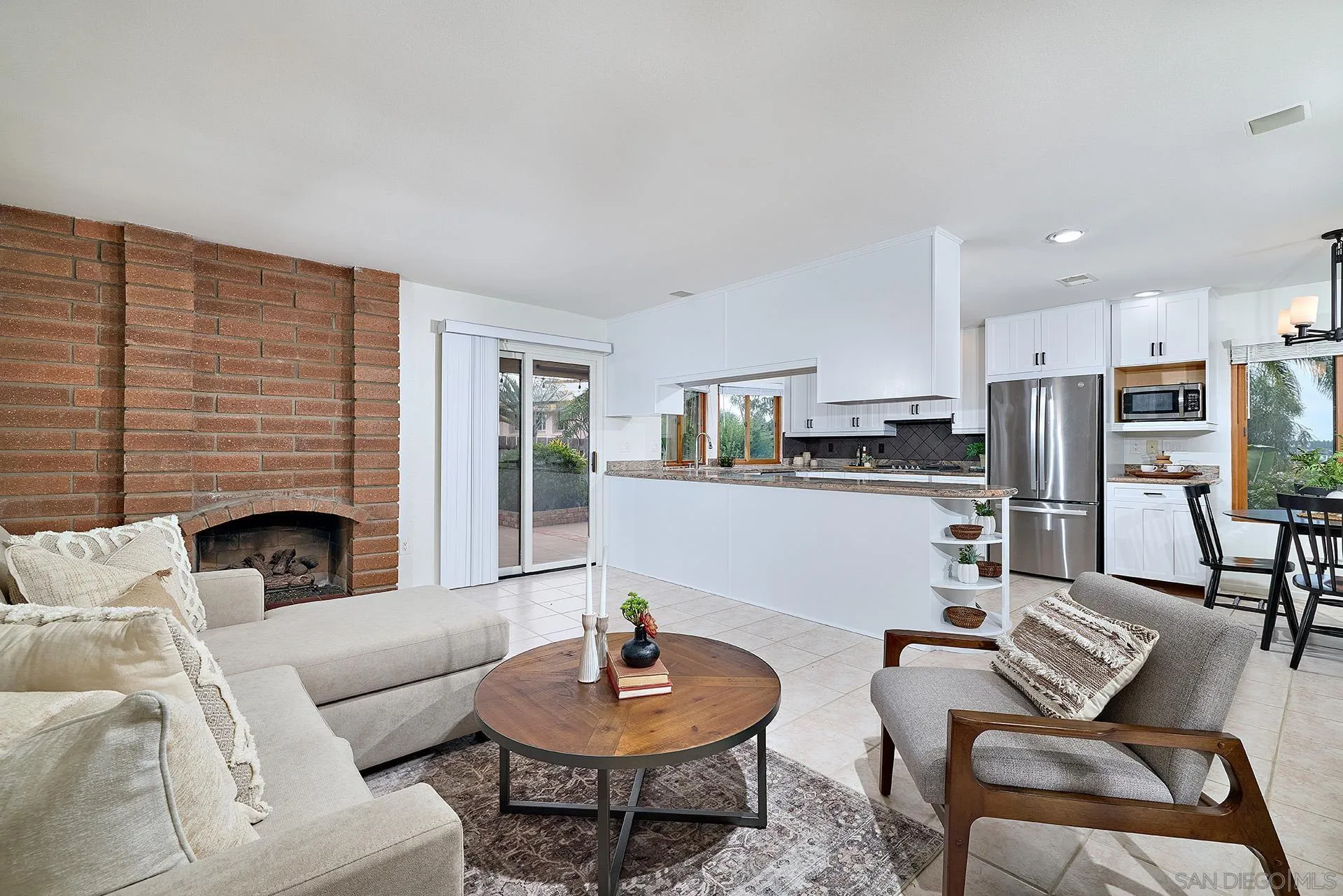 7627 Reposado Drive Carlsbad, CA 92009 - Photo 7 of 54 a living room with furniture kitchen view and a fireplace