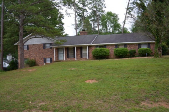 1847 Wood Valley Road Macon, GA 31211 - Photo 1 of 23 a view of a house next to a big yard and large trees