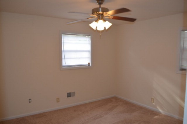 1847 Wood Valley Road Macon, GA 31211 - Photo 15 of 23 an empty room with chandelier fan