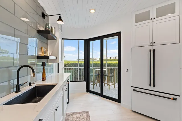 a kitchen with stainless steel appliances white cabinets and a sink