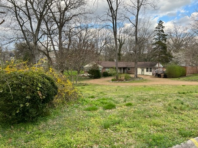 2876 Sugar Tree Road Nashville, TN 37215 - Photo 2 of 7 a view of a yard with plants and a bench