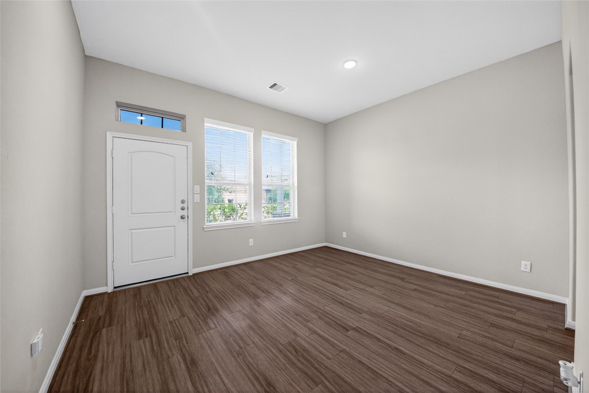 2518 Cold River Drive Humble, TX 77396 - Photo 11 of 35 an empty room with wooden floor and windows
