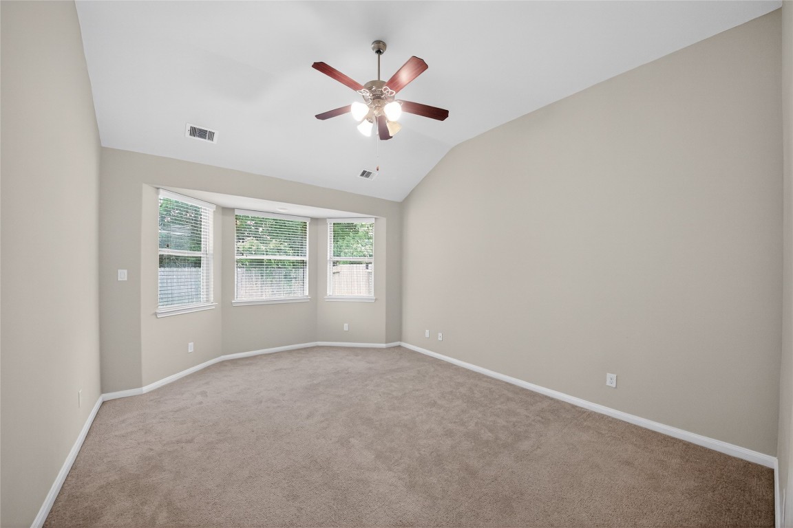 2518 Cold River Drive Humble, TX 77396 - Photo 18 of 35 an empty room with windows and fan