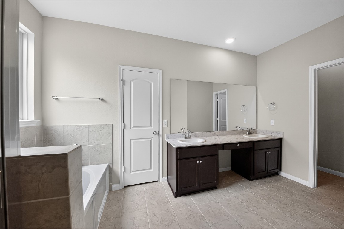 2518 Cold River Drive Humble, TX 77396 - Photo 30 of 35 a spacious bathroom with a double vanity sink and mirror
