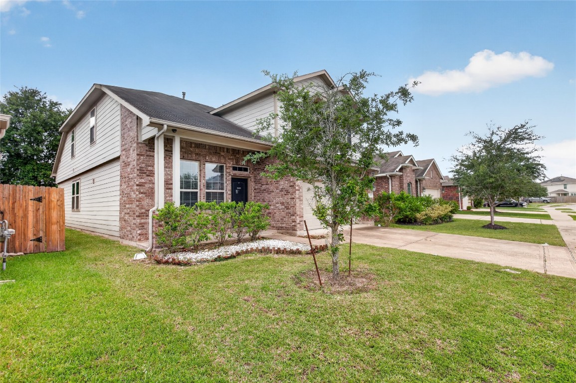 2518 Cold River Drive Humble, TX 77396 - Photo 3 of 35 a front view of a house with a yard and entertaining space