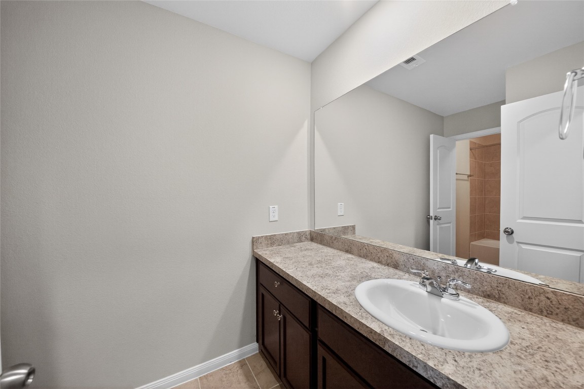 2518 Cold River Drive Humble, TX 77396 - Photo 31 of 35 a bathroom with a granite countertop sink and a mirror