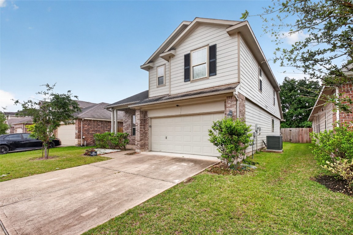 2518 Cold River Drive Humble, TX 77396 - Photo 4 of 35 a front view of a house with a yard and garage