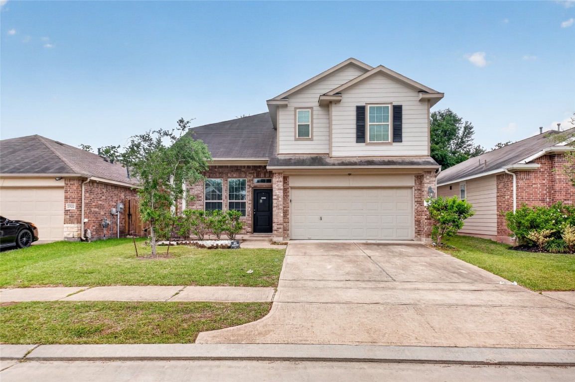 2518 Cold River Drive Humble, TX 77396 - Photo 5 of 35 a front view of a house with a yard and garage