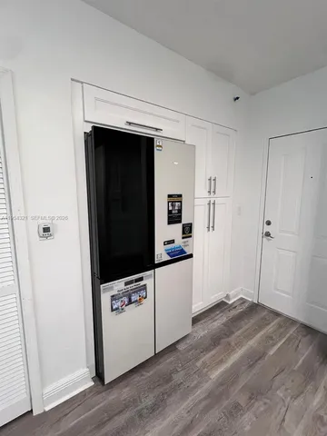 a view of a utility room with wooden floor