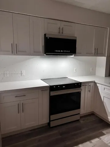 a kitchen with a stove and a microwave