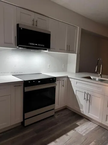 a sign that is sitting on a brick wall