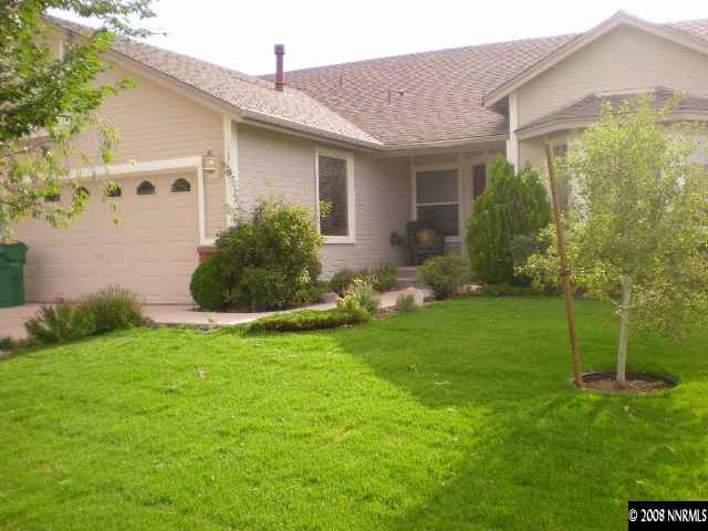 1318 Backer Way Reno, NV 89523 - Photo 2 of 6 a backyard of a house with potted plants and a large tree