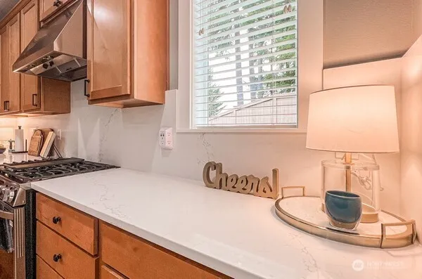 a kitchen with a stove and a white table