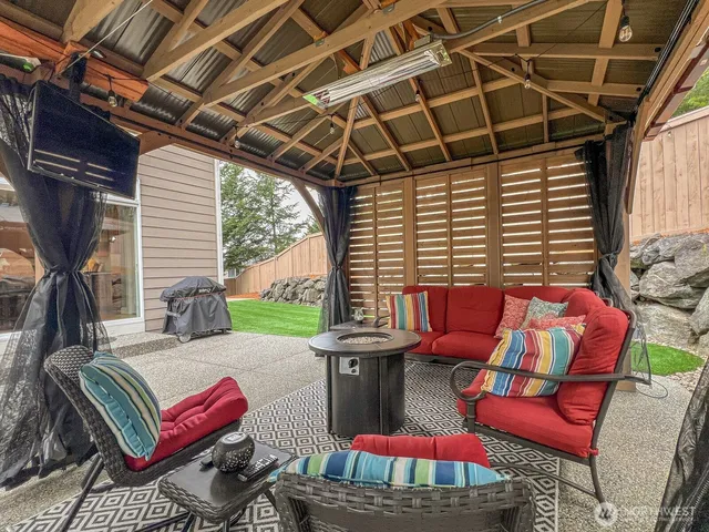 a outdoor living space with furniture and a fireplace
