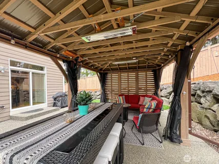 a roof deck with couch and chairs