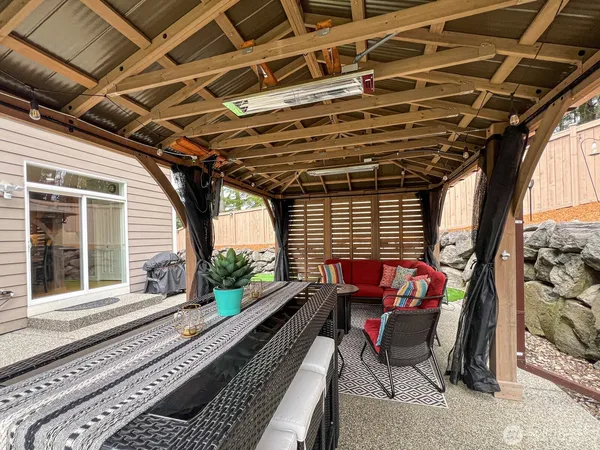 a roof deck with couch and chairs