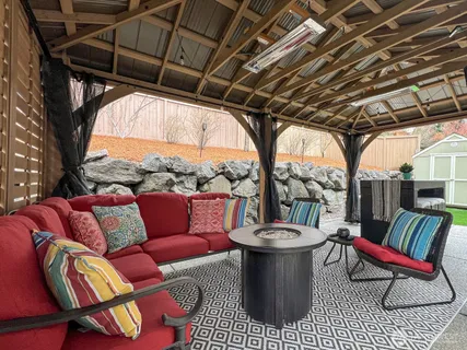 a view of house with backyard and furniture