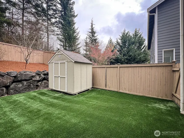 a view of a small yard with large trees and a small yard
